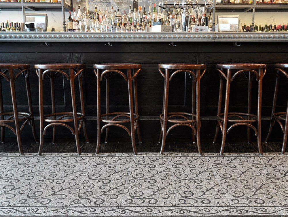 The Curve pattern from the Lace collection adds a Parisienne feel to the floor of this bistro.
