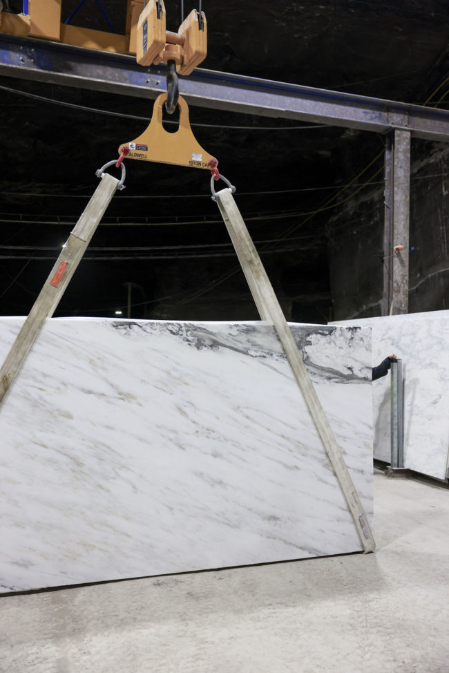 imperial danby marble slab carried by crane